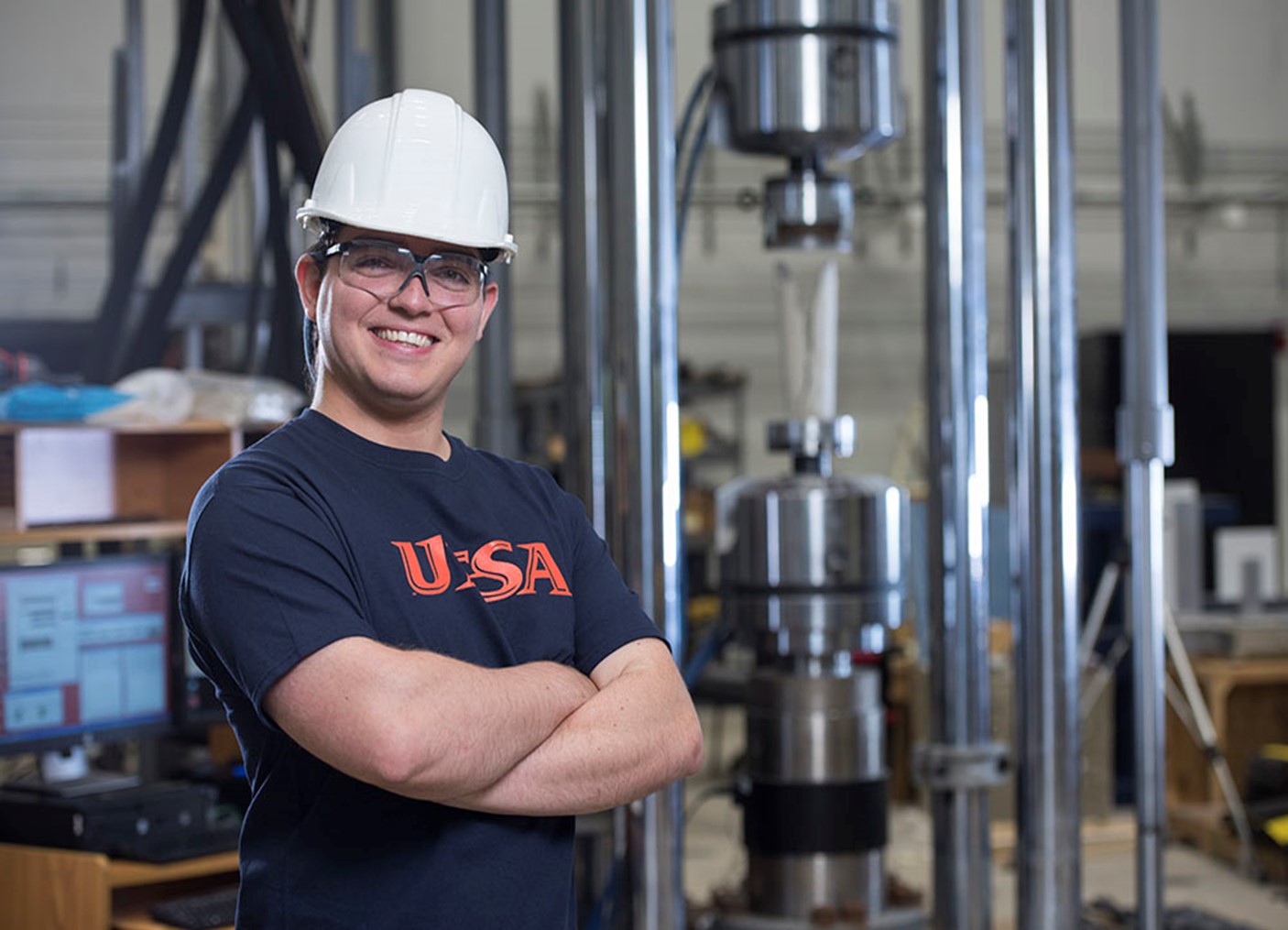 Student wearing a hard hat and glasses